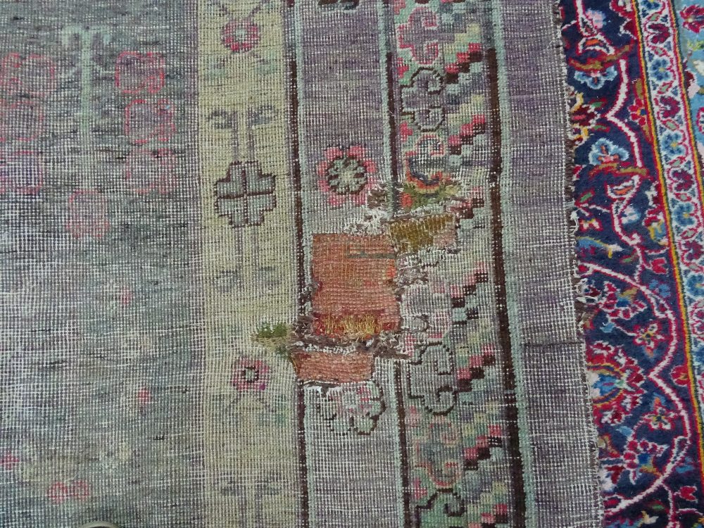 A Khotan carpet, ,the faded purple field with three bold roundels, - Image 6 of 7