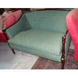 A Regency style mahogany show frame sofa with downswept arms and turned supports,