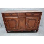 An 18th century French oak buffet with a pair of drawers over pair of shaped panel cupboards on