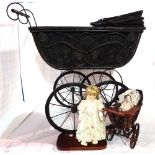 A 20th century iron framed child's pram, a similar miniature pram and a small doll.