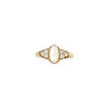 A gold, opal and diamond ring, claw set with the oval opal between diamond three stone shoulders,