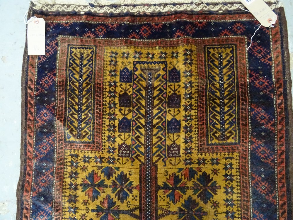 A Beluchistan prayer rug, the saffron mehrab with a flowering tree of life, plant spandrels, - Image 5 of 7