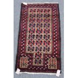 A Beluchistan prayer rug, the pale brown mehrab with matching three columns of flowering spandrels,