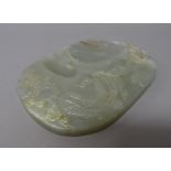 A Chinese jade inkstone, carved with a bird in the branches of flowering peony,