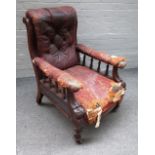 A Victorian mahogany framed rouge leather upholstered open armchair on turned supports,