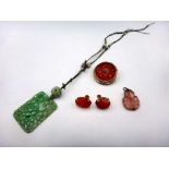 A Chinese carved jade panel shaped pendant necklace, decorated with flowers and fruit,