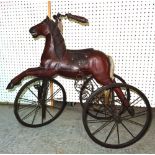 A 20th century child's painted pine tricycle formed as a horse. 72cm high.