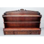 A George IV mahogany three tier bookshelf with three lower frieze drawers,