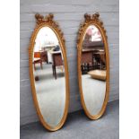 A pair of gilt framed oval mirrors,