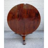 A Victorian rosewood centre table, the circular snap top on hexagonal column and three paw feet,