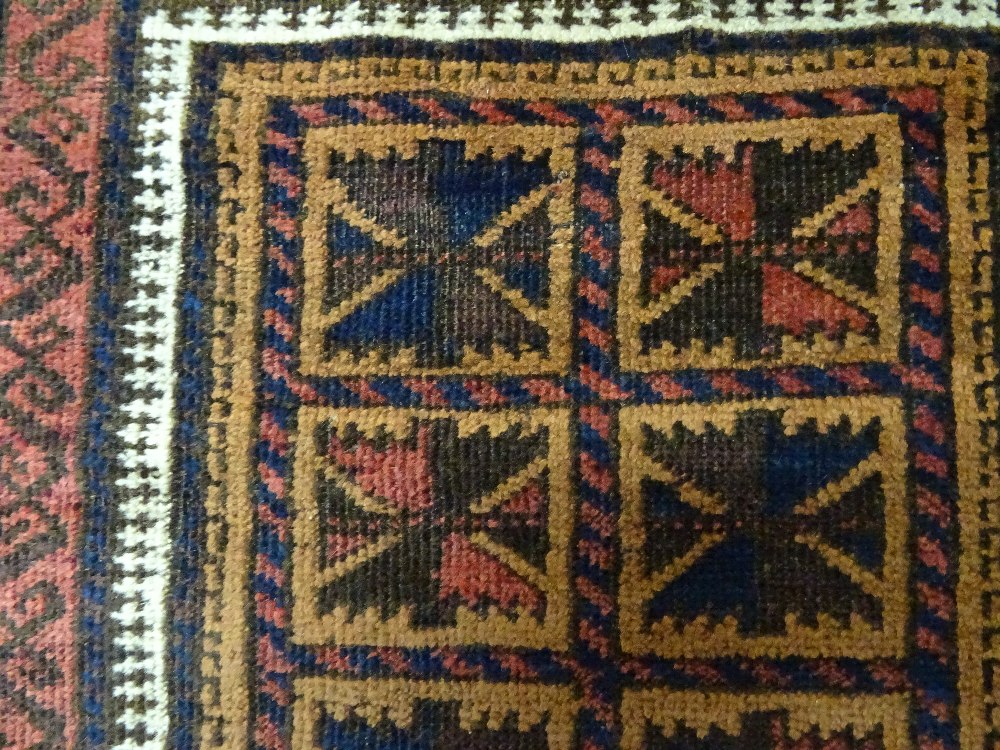A Beluchistan prayer rug, the pale brown mehrab with squared sections of single flowerheads, - Image 3 of 4