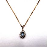 A 9ct gold, sapphire and diamond set oval cluster pendant, with a 9ct gold oval link neckchain,