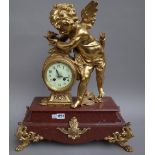 A French gilt metal mounted rouge marble figural mantel clock, early 20th century,
