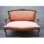 A Louis XV style carved walnut salon suite, to comprise; a sofa 125cm wide x 99cm high,