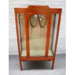 A 20th century floral painted satinwood single door display cabinet, on tapering square supports,