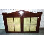 An early 19th century continental mahogany hanging two door cabinet, with architectural cornice,