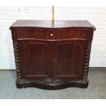 A Victorian mahogany serpentine cabinet with single drawer over panelled doors flanked by