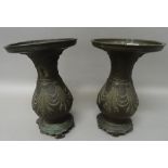 A pair of Asian bronze vases, circa 1900, of pear form with everted rims,