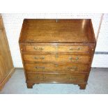 A 19th century oak bureau with fitted interior on bracket feet, 89cm wide x 99cm high.