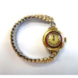 A gold cased and synthetic ruby set circular cased lady's wristwatch,