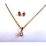 A gold and diamond single stone pendant, claw set with a circular cut diamond,