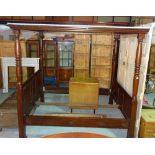 A 20th century mahogany framed four poster bed on ring turned column supports and block feet,