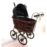 A 20th century stained pine and wrought iron miniature doll's pram.