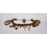 A gold, hollow curb link charm bracelet, detailed 9 C, fitted with ten pendants and charms,