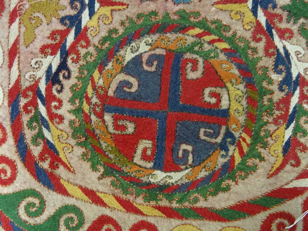 An Uzbek felt saddle cloth, the ivory field with two column of four cross roundels, - Image 5 of 6