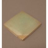 A silver and gold lady's square powder compact,