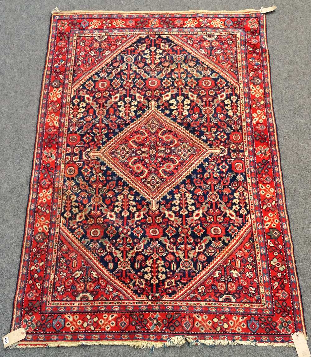 A Mahal rug, Persian, the dark indigo field with a madder central diamond, matching spandrels,