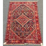 A Mahal rug, Persian, the dark indigo field with a madder central diamond, matching spandrels,