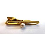 A gentleman's gold tie clip, mounted with a central cultured pearl, detailed K 14, by Mikimoto,