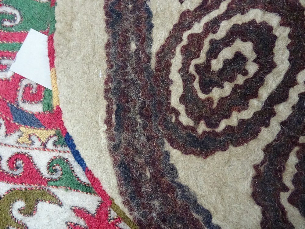 An Uzbek felt saddle cloth, the ivory field with two column of four cross roundels, - Image 6 of 6