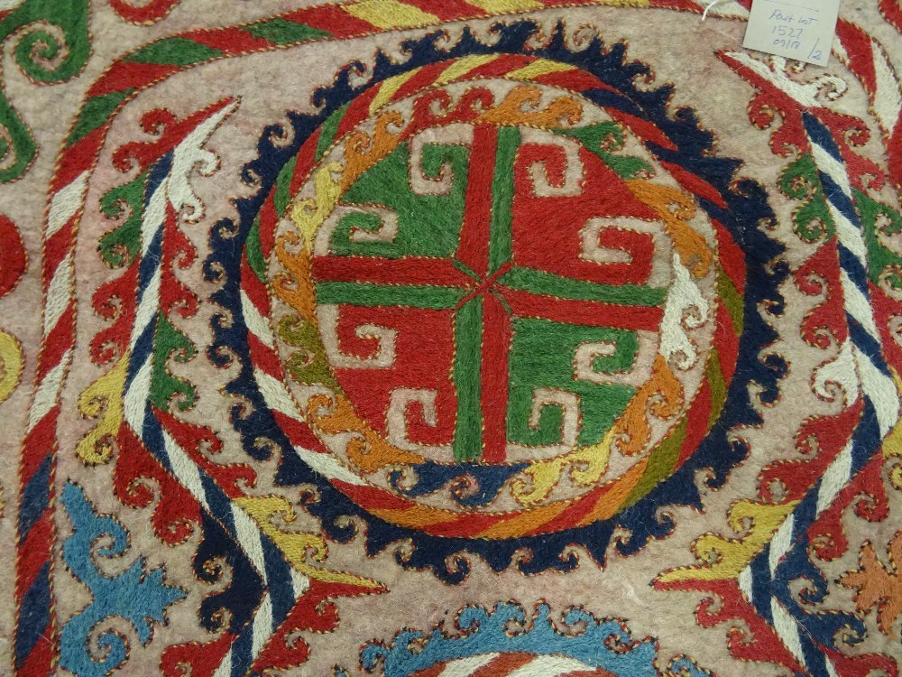 An Uzbek felt saddle cloth, the ivory field with two column of four cross roundels, - Image 4 of 6