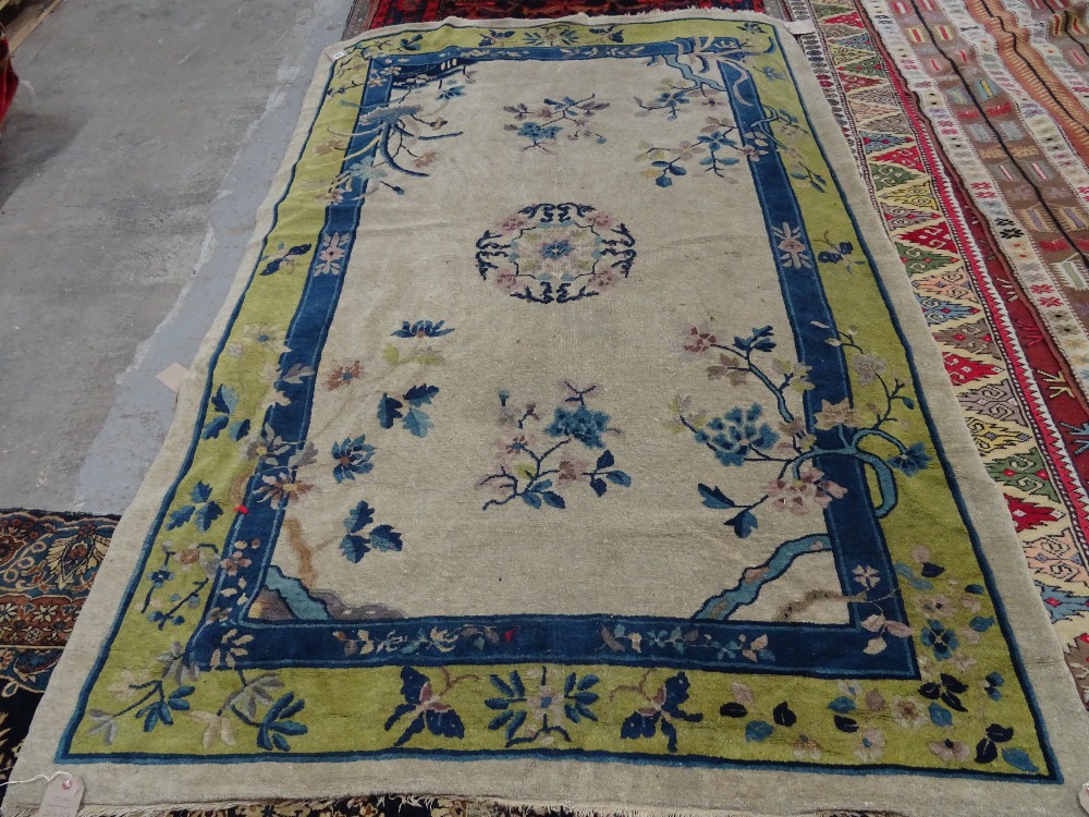 A Chinese carpet, the ivory field with a central roundel, floral sprays, - Image 3 of 5