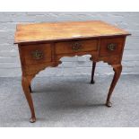 A mid-18th century oak lowboy with three frieze drawers on cabriole supports,