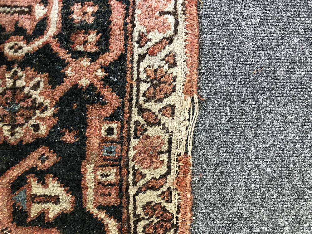 An Heriz carpet, Persian, the madder field with a bold angular pole medallion, ivory spandrels, - Image 23 of 23