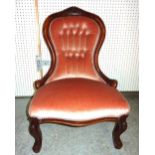 A Victorian mahogany framed low armchair with pink button back upholstery, 56cm wide.