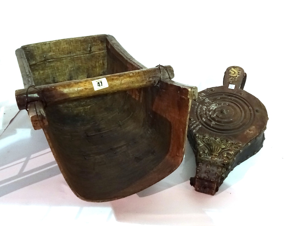 An early 20th century wooden grain scoop and a pair of carved walnut bellows.