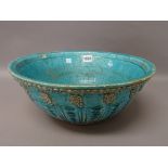 A large Persian turquoise glazed pottery bowl,