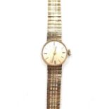 An Omega 9ct gold lady's bracelet wrist watch, the signed dial with baton shaped numerals,