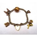 A gold twin curb link charm bracelet, with a 9ct gold heart shaped padlock clasp,