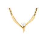 A gold and diamond single stone necklace, the front in a 'V' shaped design,