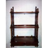 A 20th century mahogany fret cut three tier hanging wall shelf with two short drawers,