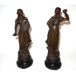 A pair of spelter figures modelled as females, 36cm high.