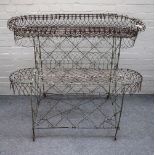 An Edwardian wire work double height oval plant stand, 133cm wide x 103cm high x 63cm deep.