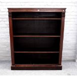 A William IV and later rosewood and mahogany floor standing open four tier bookcase, on plinth base,