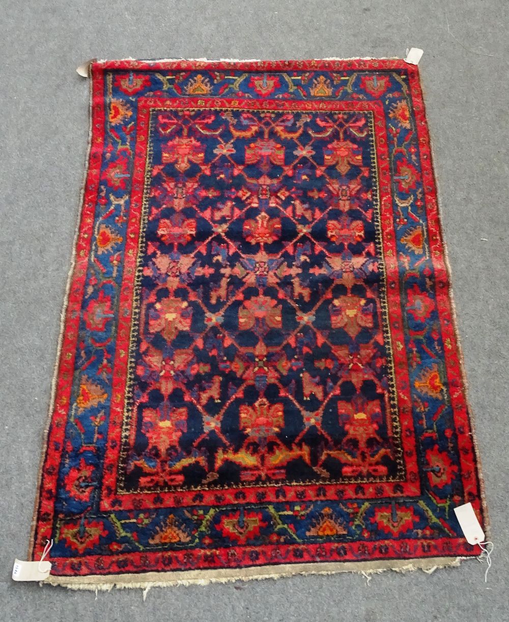 A Mahal rug, Persian, the indigo field with a trellis design, indigo border of palmettes and vine,