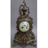 A French Louis XVI style metal mantel clock, with urn finial, enamel dial,